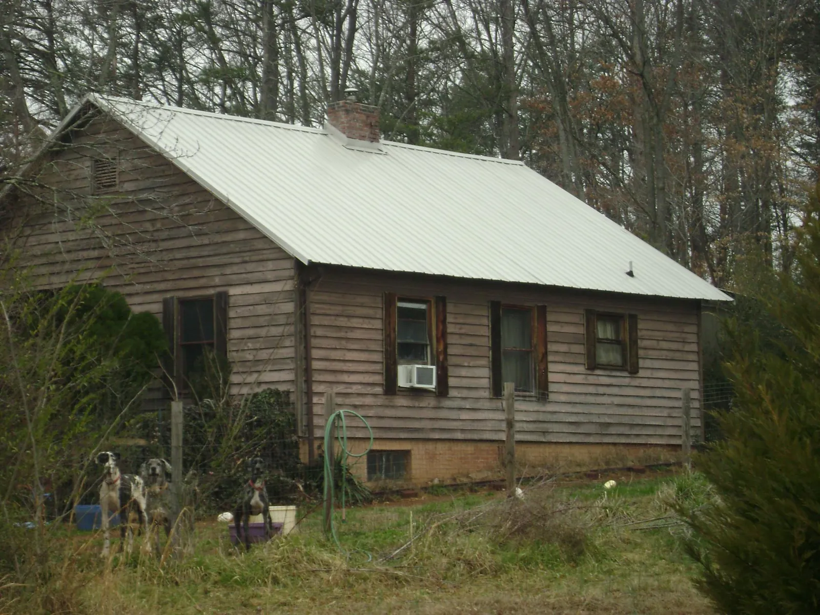 White metal roof on an old wood sided farmhouse, from a Metal Roof Installation job in Schellsburg